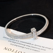 Load image into Gallery viewer, Cross of Light: Zircon-Encrusted Silver Bangle
