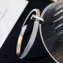 Load image into Gallery viewer, Cross of Light: Zircon-Encrusted Silver Bangle
